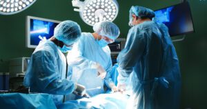 Surgical team performing spinal surgery, representing why families may explore conservative scoliosis correction options at 100+Living Health Centres in Kelowna.